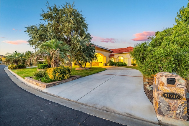 mediterranean / spanish-style home featuring a yard