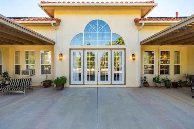 exterior space featuring french doors, cooling unit, and a patio