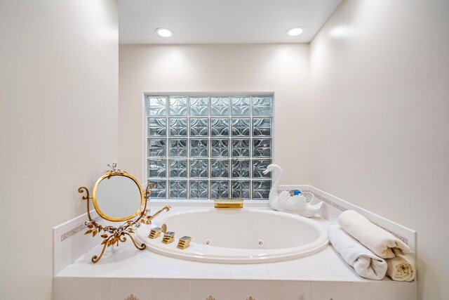 bathroom featuring a relaxing tiled tub