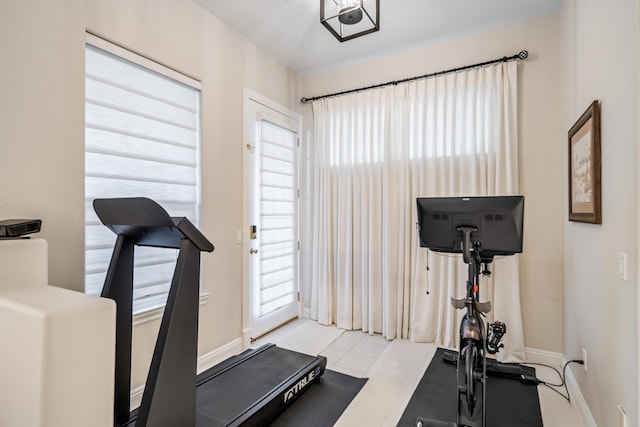 workout room featuring light tile patterned floors and a wealth of natural light