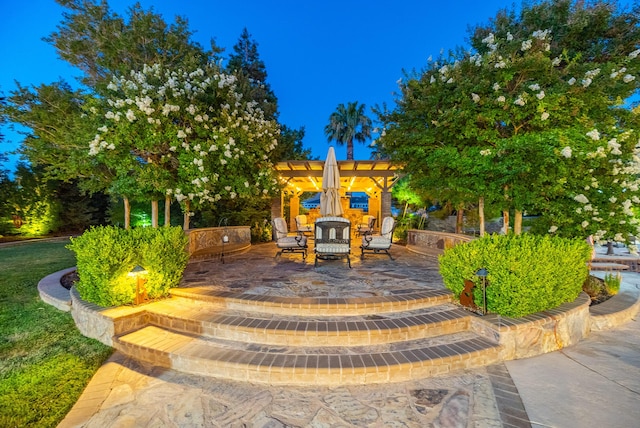 view of playground featuring a pergola and a patio area