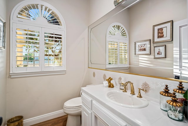 bathroom featuring hardwood / wood-style floors, vanity, and toilet