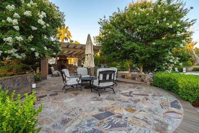 view of patio / terrace featuring an outdoor stone fireplace