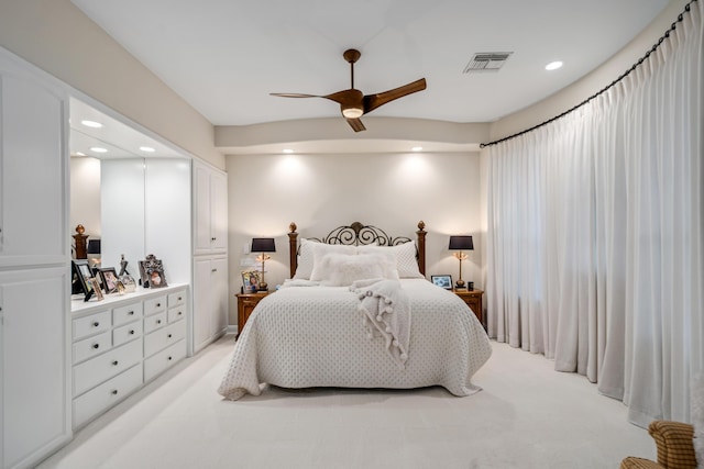 bedroom with ceiling fan and light colored carpet