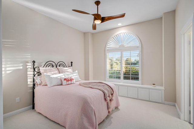 bedroom featuring light carpet and ceiling fan