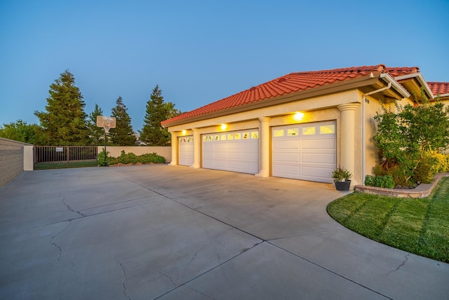 property exterior at dusk featuring a garage