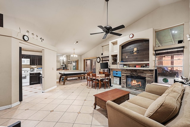 tiled living room featuring ceiling fan, a fireplace, and high vaulted ceiling