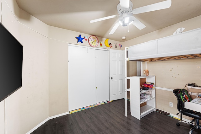 home office with ceiling fan and dark hardwood / wood-style floors