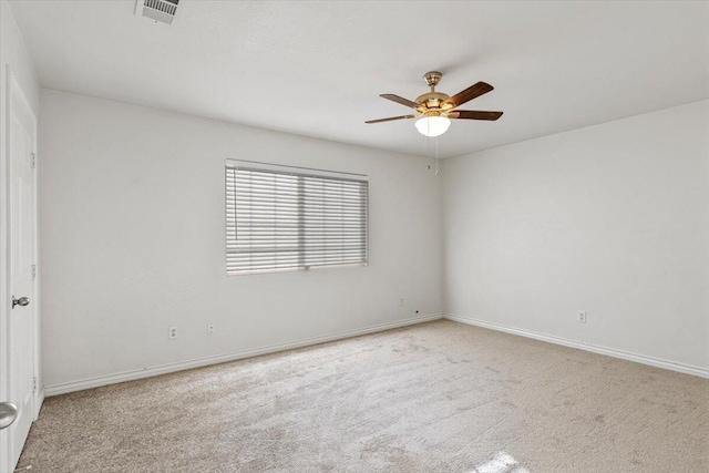 unfurnished room featuring baseboards, carpet flooring, visible vents, and a ceiling fan