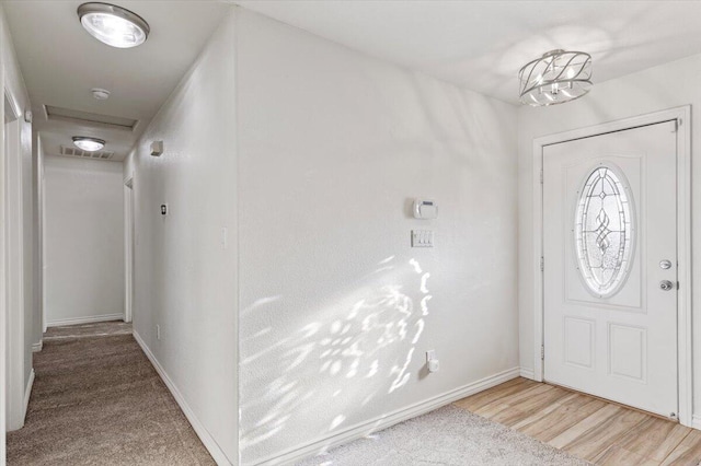 foyer entrance featuring light wood-type flooring, visible vents, and baseboards