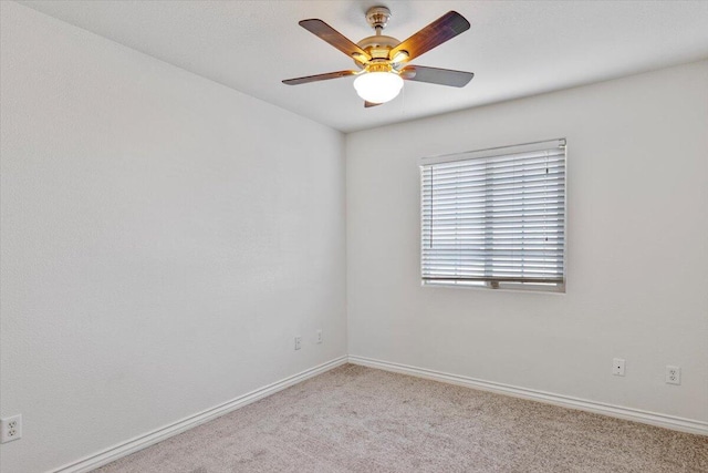 unfurnished room featuring ceiling fan, carpet, and baseboards