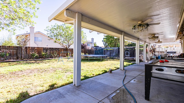 2839 Minford St, Lancaster, CA 93536 - fenced backyard with a trampoline, a patio area, and a ceiling fan