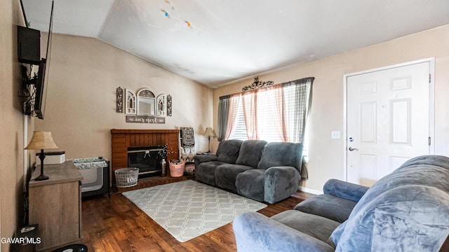 2839 Minford St, Lancaster, CA 93536 - living room featuring dark wood-style flooring, a brick fireplace, and lofted ceiling