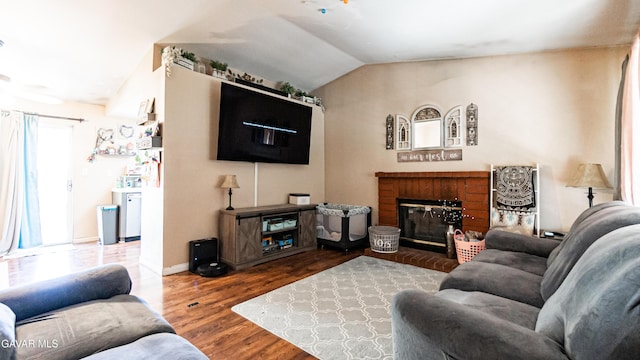2839 Minford St, Lancaster, CA 93536 - living room featuring wood finished floors, lofted ceiling, and a brick fireplace