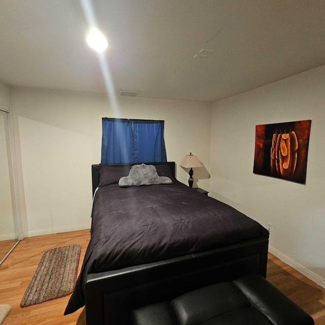 bedroom with wood-type flooring