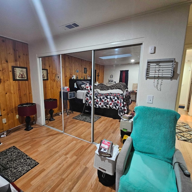 bedroom with a closet and wood walls