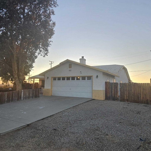 property exterior at dusk with a garage