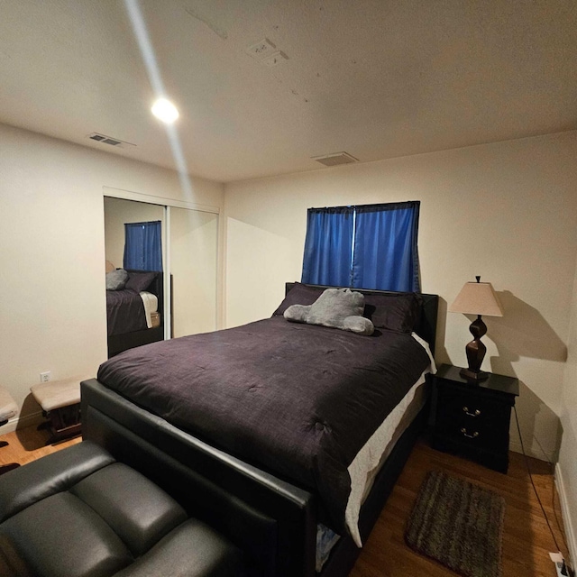 bedroom featuring hardwood / wood-style flooring and a closet