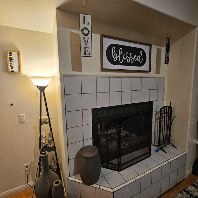 details with hardwood / wood-style flooring and a fireplace