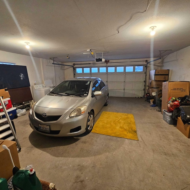 garage featuring separate washer and dryer and a garage door opener