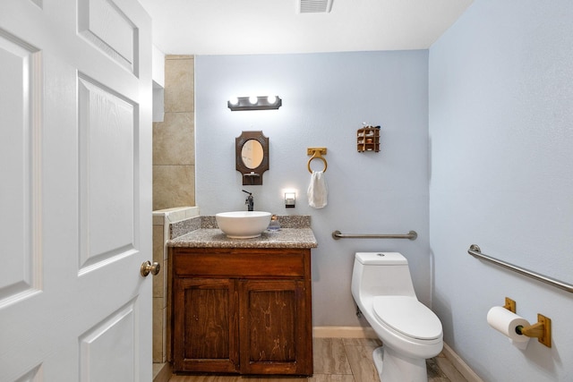 bathroom featuring vanity, toilet, and wood-type flooring