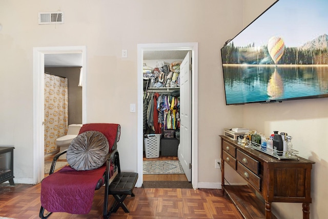 sitting room with dark parquet flooring