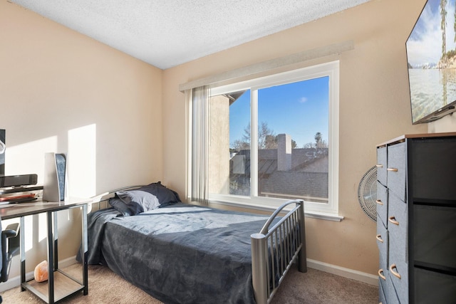 carpeted bedroom featuring a textured ceiling