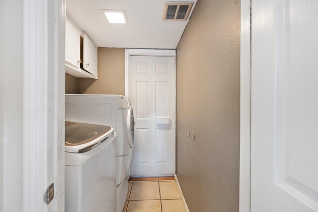 44627 E 11th St, Lancaster, CA 93535 - washroom featuring washer and clothes dryer, cabinet space, and light tile patterned floors