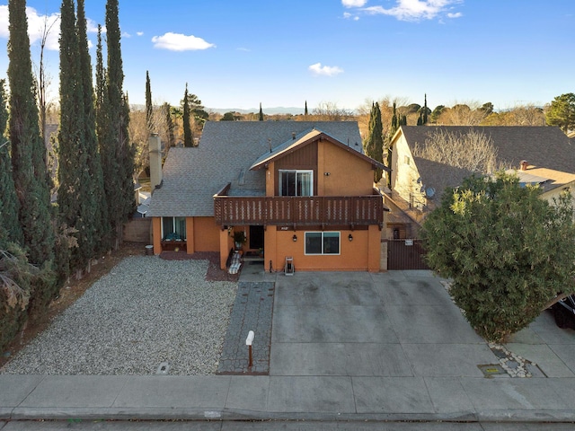 44627 E 11th St, Lancaster, CA 93535 - view of front of home with a balcony, a gate, and a shingled roof