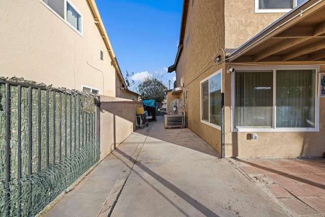 44627 E 11th St, Lancaster, CA 93535 - view of side of property with stucco siding, a patio area, and a gate