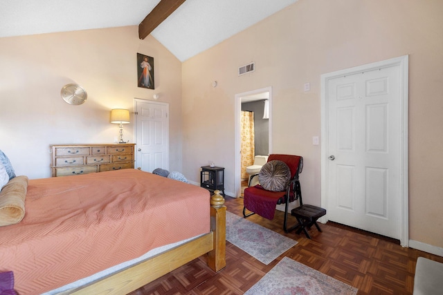 bedroom with beamed ceiling, high vaulted ceiling, dark parquet flooring, and connected bathroom