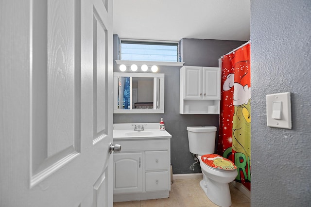 bathroom featuring tile patterned flooring, vanity, and toilet