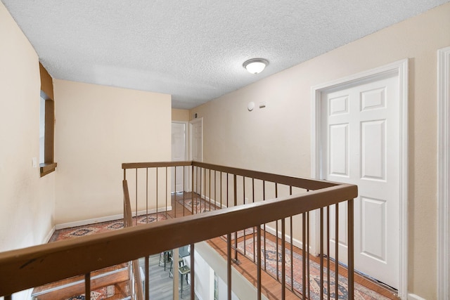 hallway featuring a textured ceiling