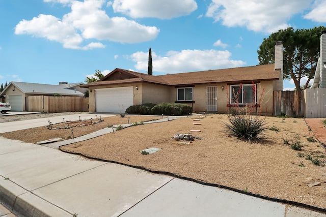 single story home with driveway, a chimney, fence, an attached garage, and stucco siding