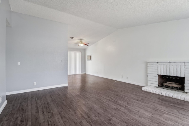 unfurnished living room with a brick fireplace, ceiling fan, dark wood-style floors, and lofted ceiling