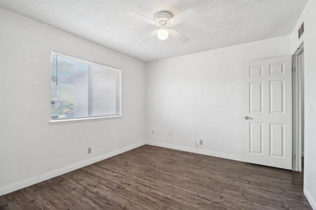 unfurnished room with dark wood-style flooring, ceiling fan, a textured ceiling, baseboards, and visible vents