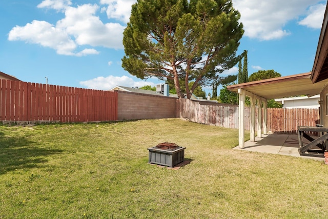 view of yard with a fenced backyard, a patio, and an outdoor fire pit