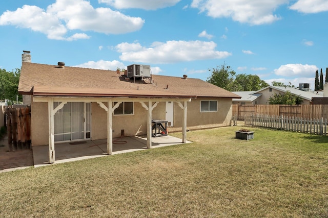 back of property with central AC, a fenced backyard, a patio, a fire pit, and stucco siding