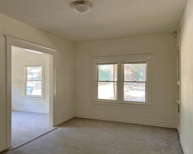 unfurnished room featuring light colored carpet