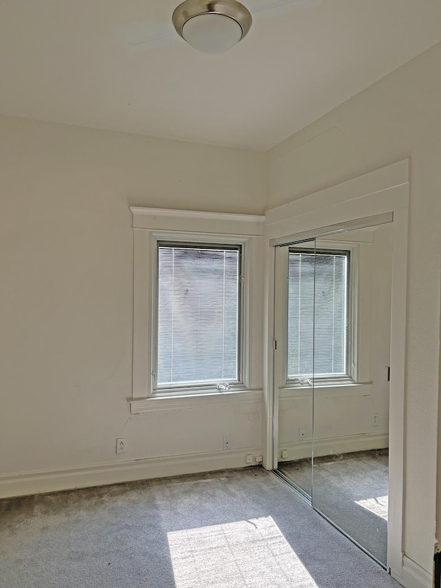 interior space with light carpet and a closet