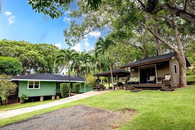 6281 Hauaala Rd Unit 2, Kapaa, HI 96746 - view of front of house featuring a front lawn, a deck, and roof with shingles