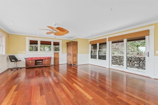 65-1104 Hokuula Rd, Kamuela, HI 96743 - unfurnished living room with healthy amount of natural light, wood finished floors, a wainscoted wall, ceiling fan, and crown molding