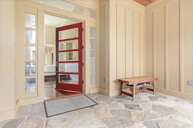 65-1104 Hokuula Rd, Kamuela, HI 96743 - doorway to outside featuring light stone finish floors and a decorative wall