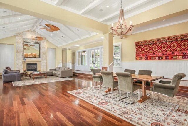 65-1104 Hokuula Rd, Kamuela, HI 96743 - dining space featuring wood finished floors, wainscoting, a chandelier, a large fireplace, and ceiling fan