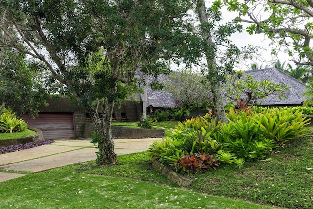 4221 Anini Vista Dr # A, Kilauea, HI 96754 - view of front facade featuring concrete driveway, a front yard, and a garage