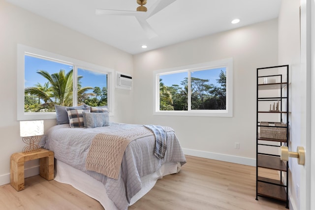 15-1757 4th Ave, Keaau, HI 96749 - bedroom featuring wood finished floors, a wall mounted AC, baseboards, a skylight, and recessed lighting