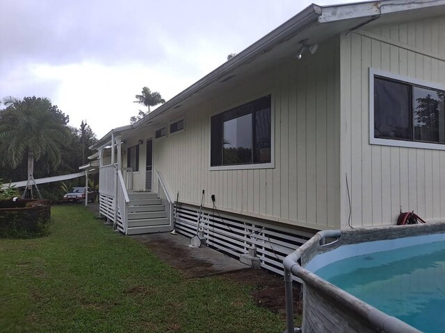 11-3193 Hibiscus St, Mountain View, HI 96771 - view of property exterior with a lawn