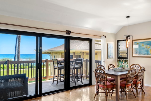 4460 Nehe Rd Unit 212, Lihue, HI 96766 - dining room with wood finished floors, vaulted ceiling, a water view, and baseboards