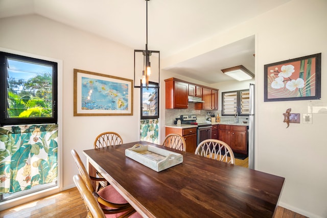 4460 Nehe Rd Unit 212, Lihue, HI 96766 - dining room with light wood-style flooring, plenty of natural light, and lofted ceiling