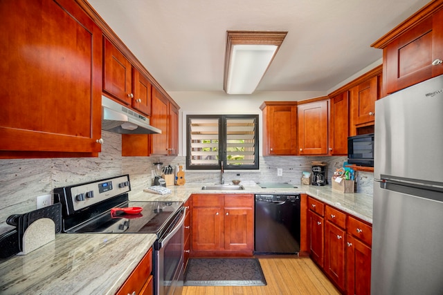 4460 Nehe Rd Unit 212, Lihue, HI 96766 - kitchen featuring black appliances, under cabinet range hood, a sink, tasteful backsplash, and light wood finished floors